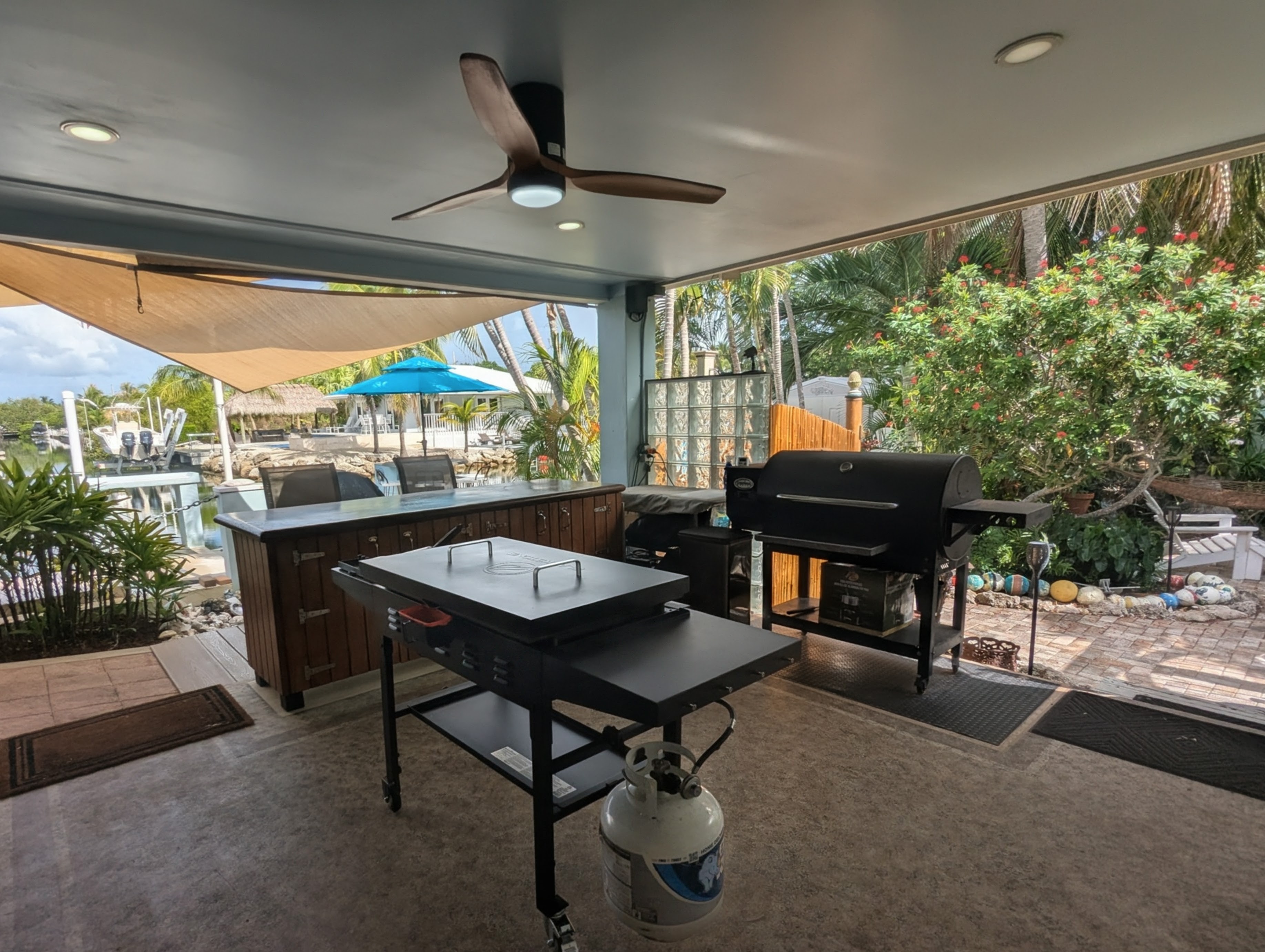 Second porch features an Outdoor Kitchen with new Blackstone grill. New Pitboss pellet grill, outdoor freezer and full concrete bar with barstools.